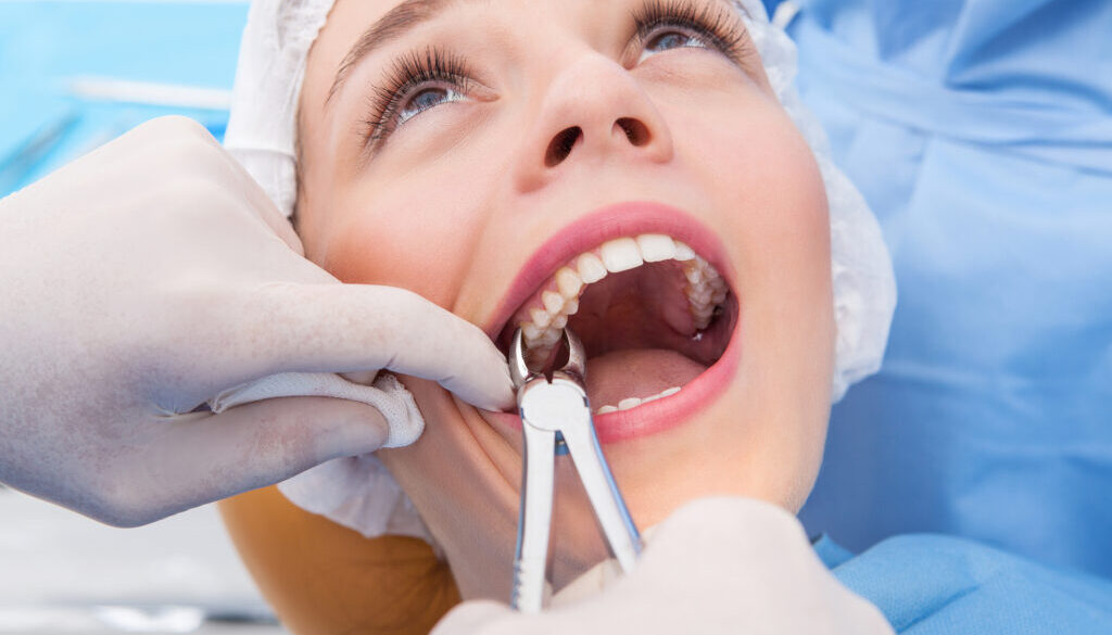 Woman having tooth removed