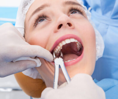 Woman having tooth removed