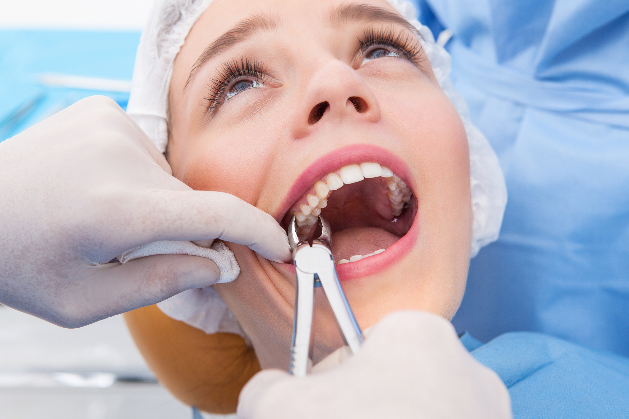 Woman having tooth removed