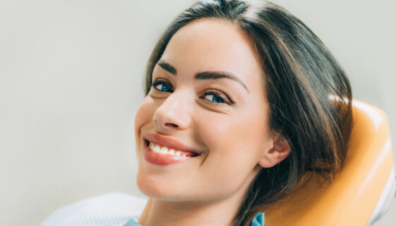 Beautiful female patient sitting in dentist chair