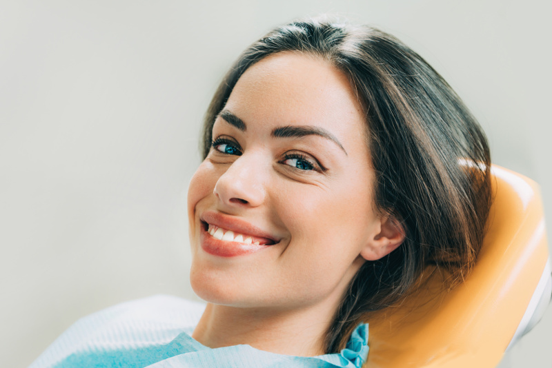 Beautiful female patient sitting in dentist chair